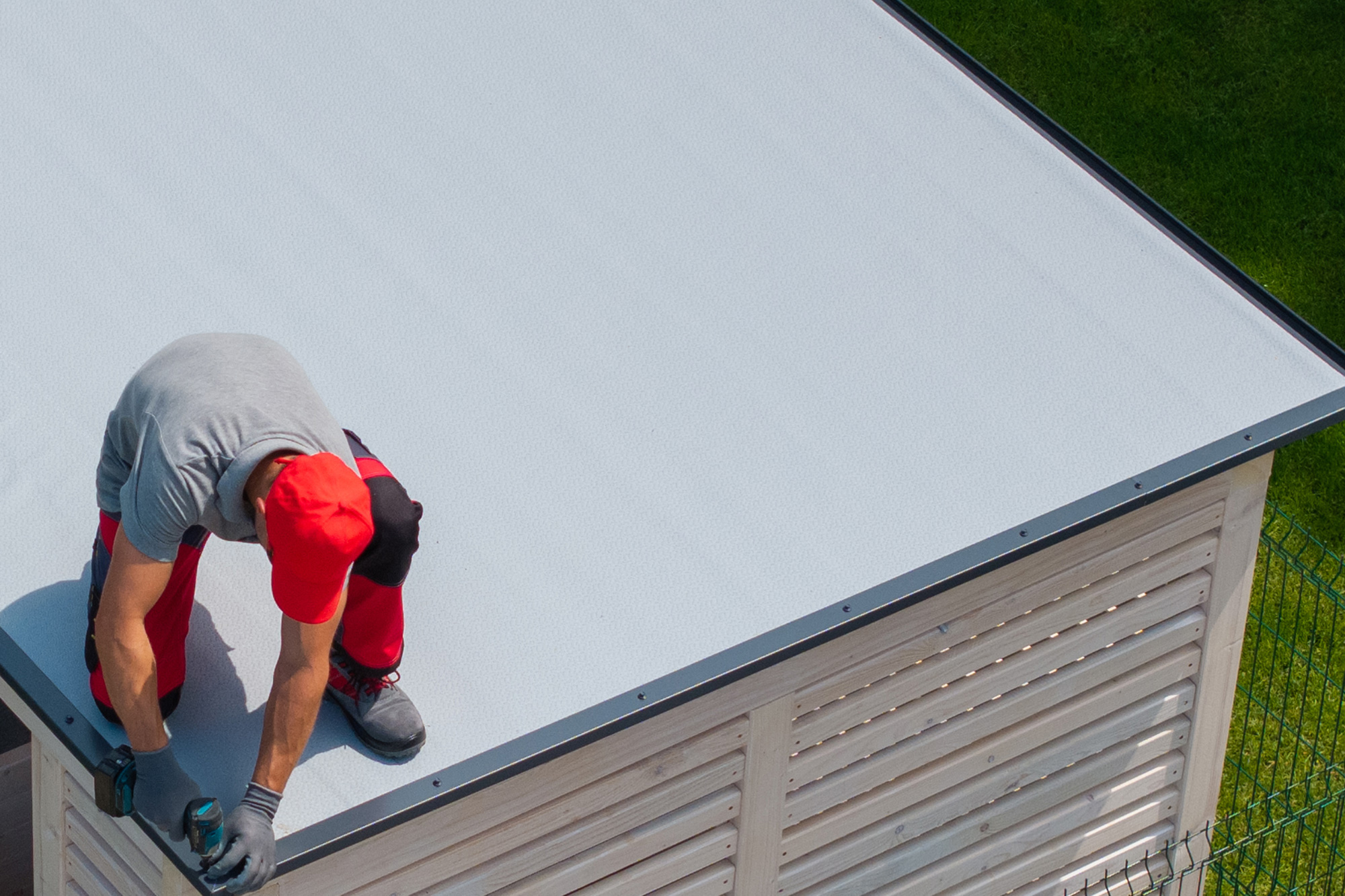 Roofer installing flat roof Roofer installing flat roof